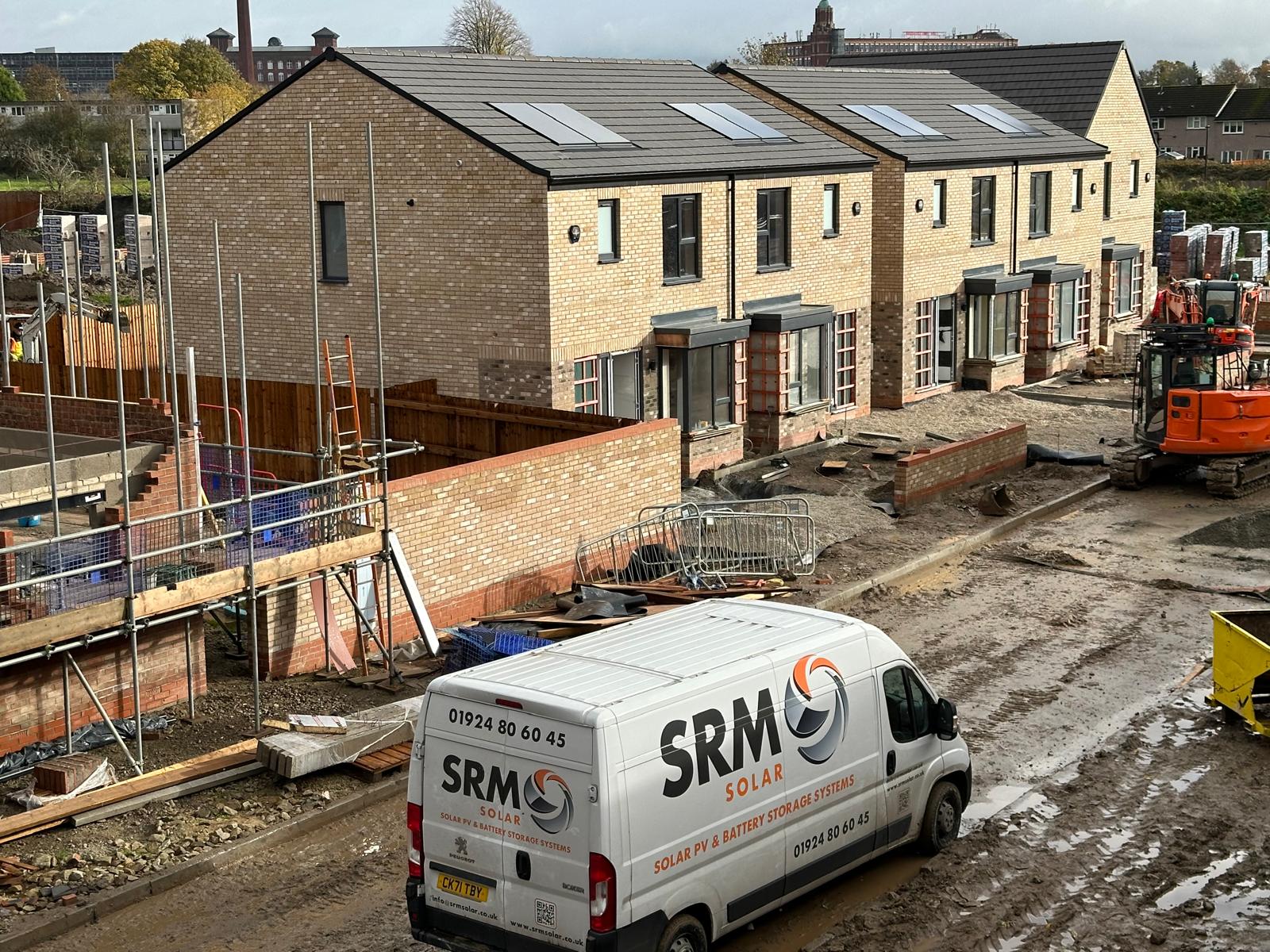 SRM Solar van at a new build development with solar panels installed on rooftops in Yorkshire