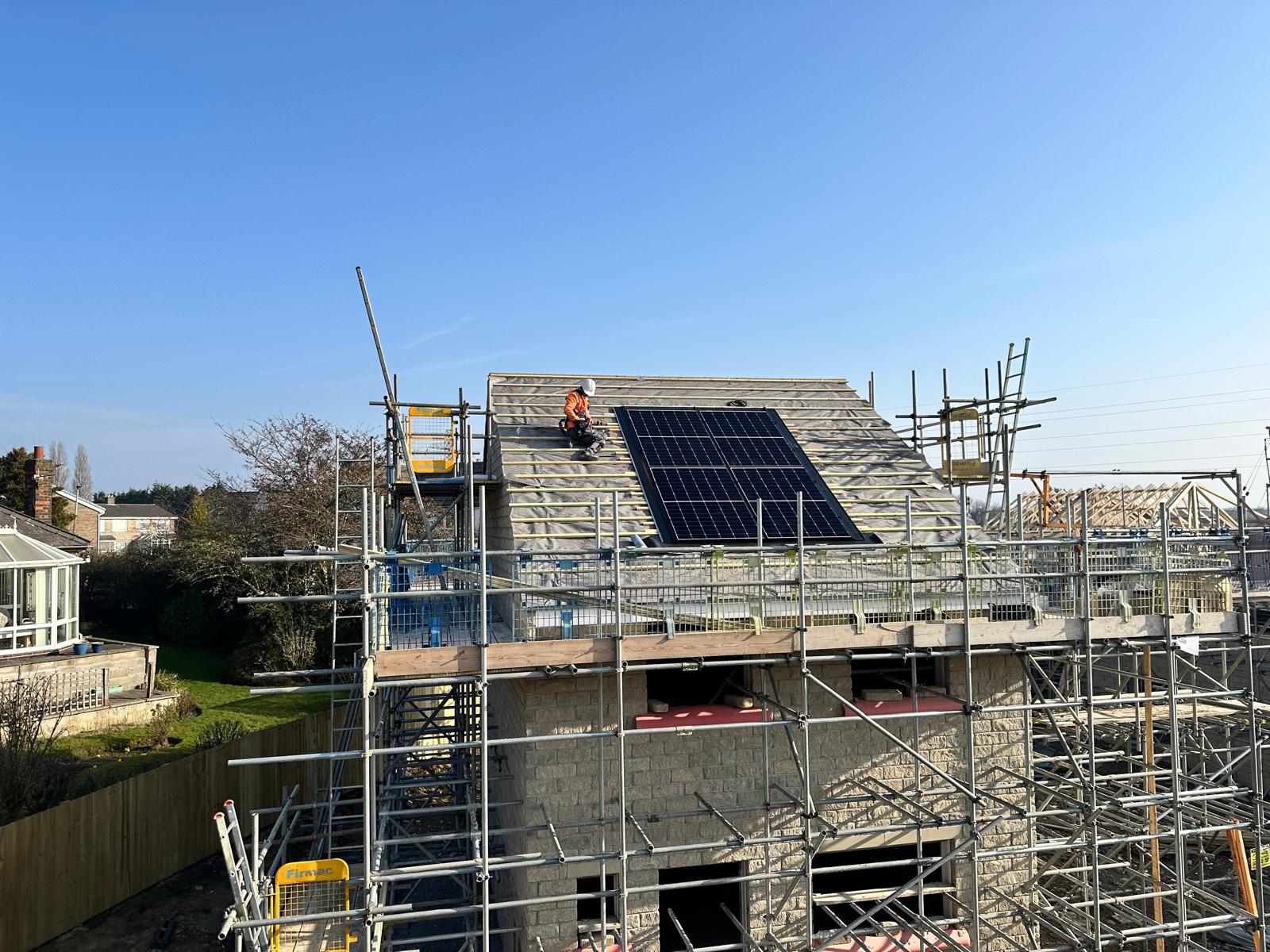 SRM Solar engineer installing solar panels on a new build roof